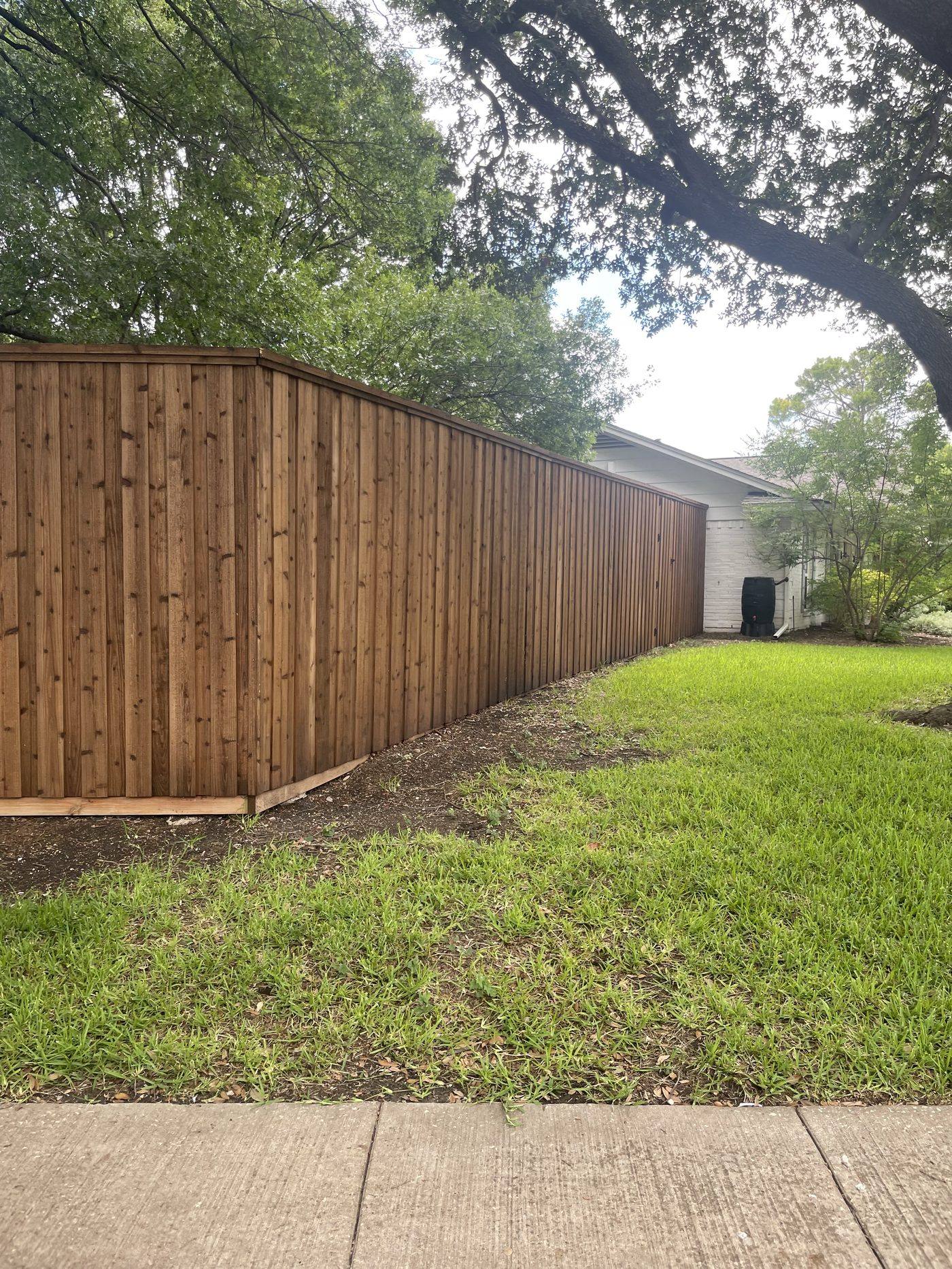 Natural cedar board-on-board fence with cap rail